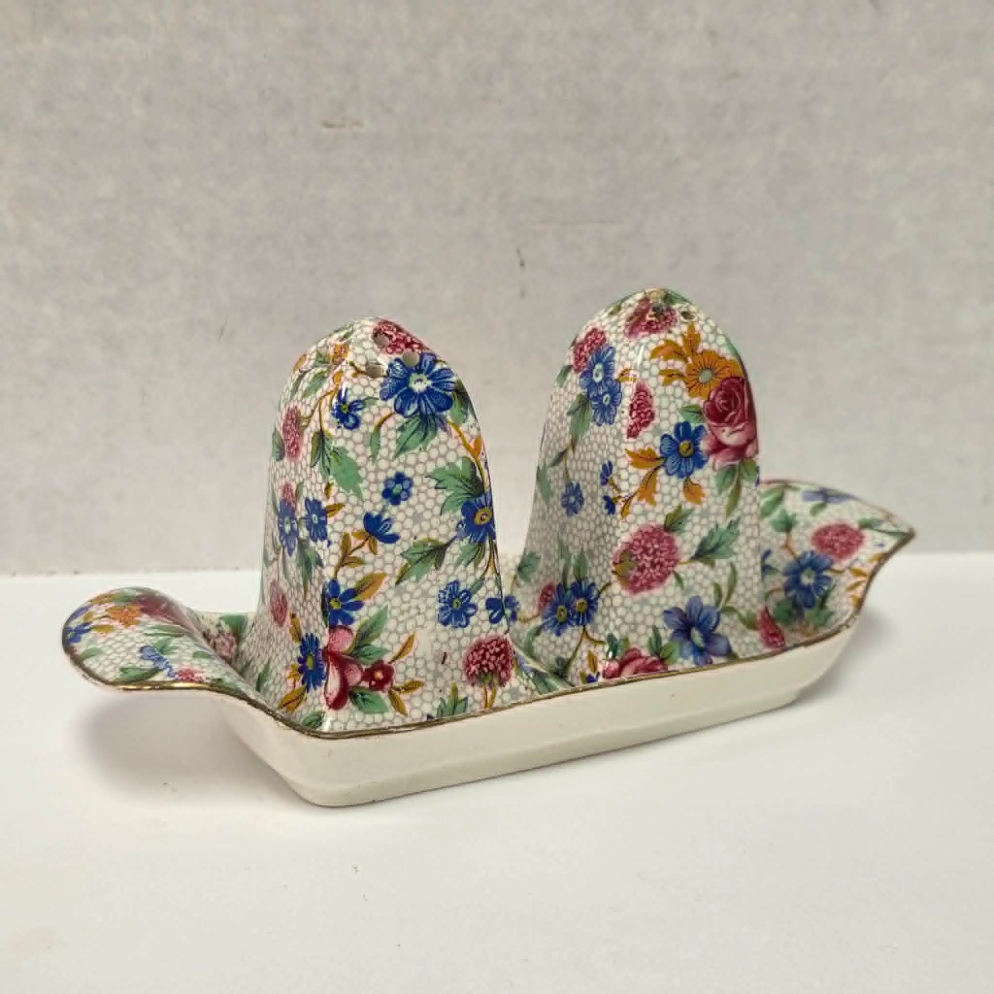 Antique Royal Grimwades Old Cottage Chintz salt and pepper shakers with matching tray.
