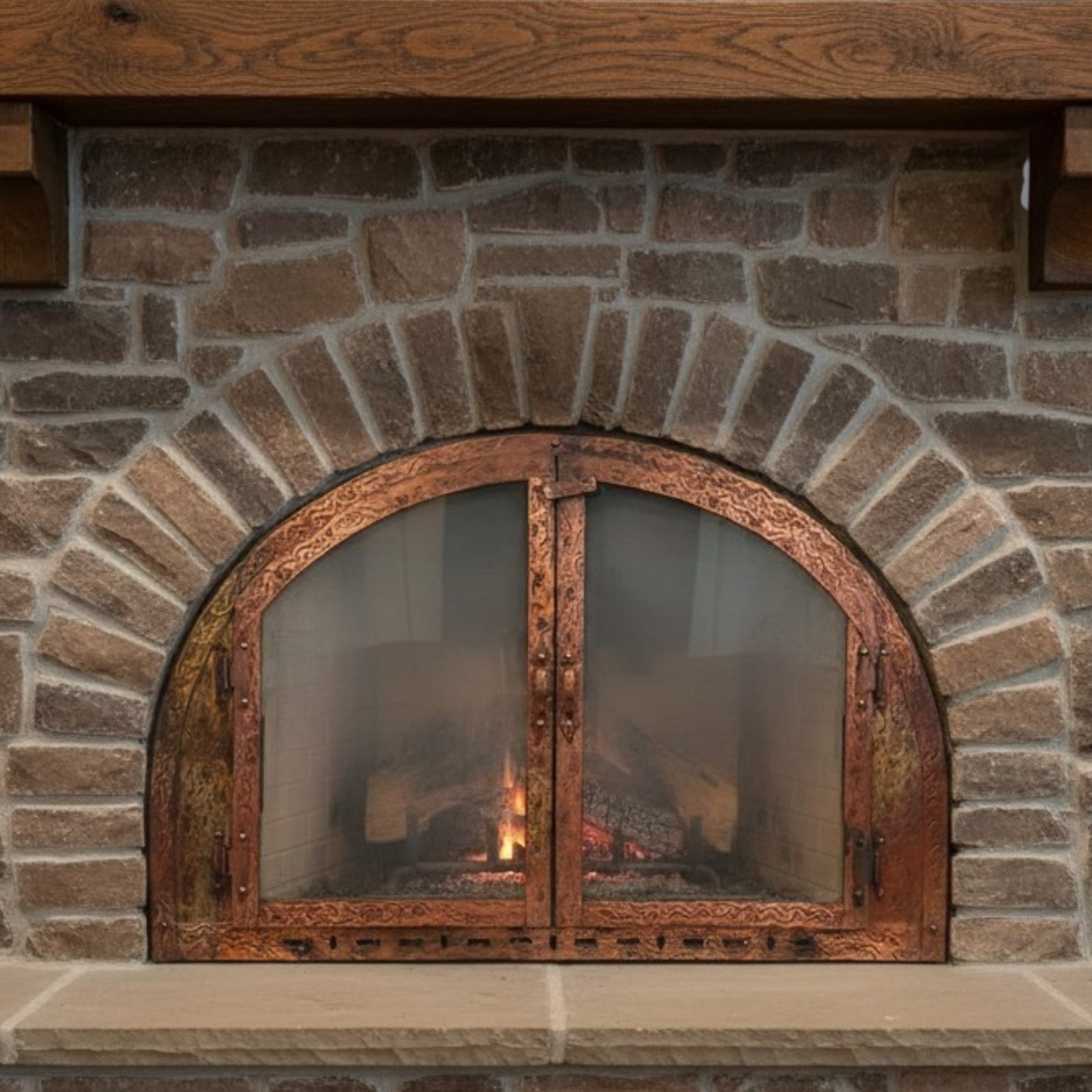 Brick fireplace with a decorative metal door