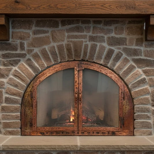 Brick fireplace with a decorative metal door