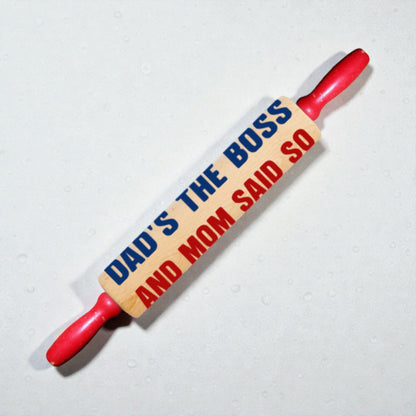 Rolling pin with humorous text on a light background