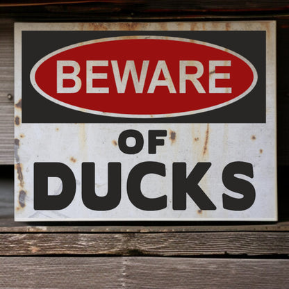 Rustic 'Beware of Ducks' sign on a wooden surface