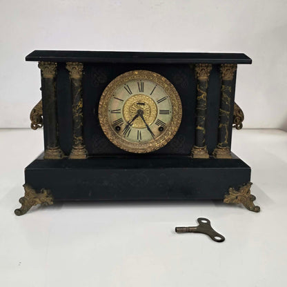 Antique E. Ingraham mantel clock with marbleized columns and bell strike movement.
