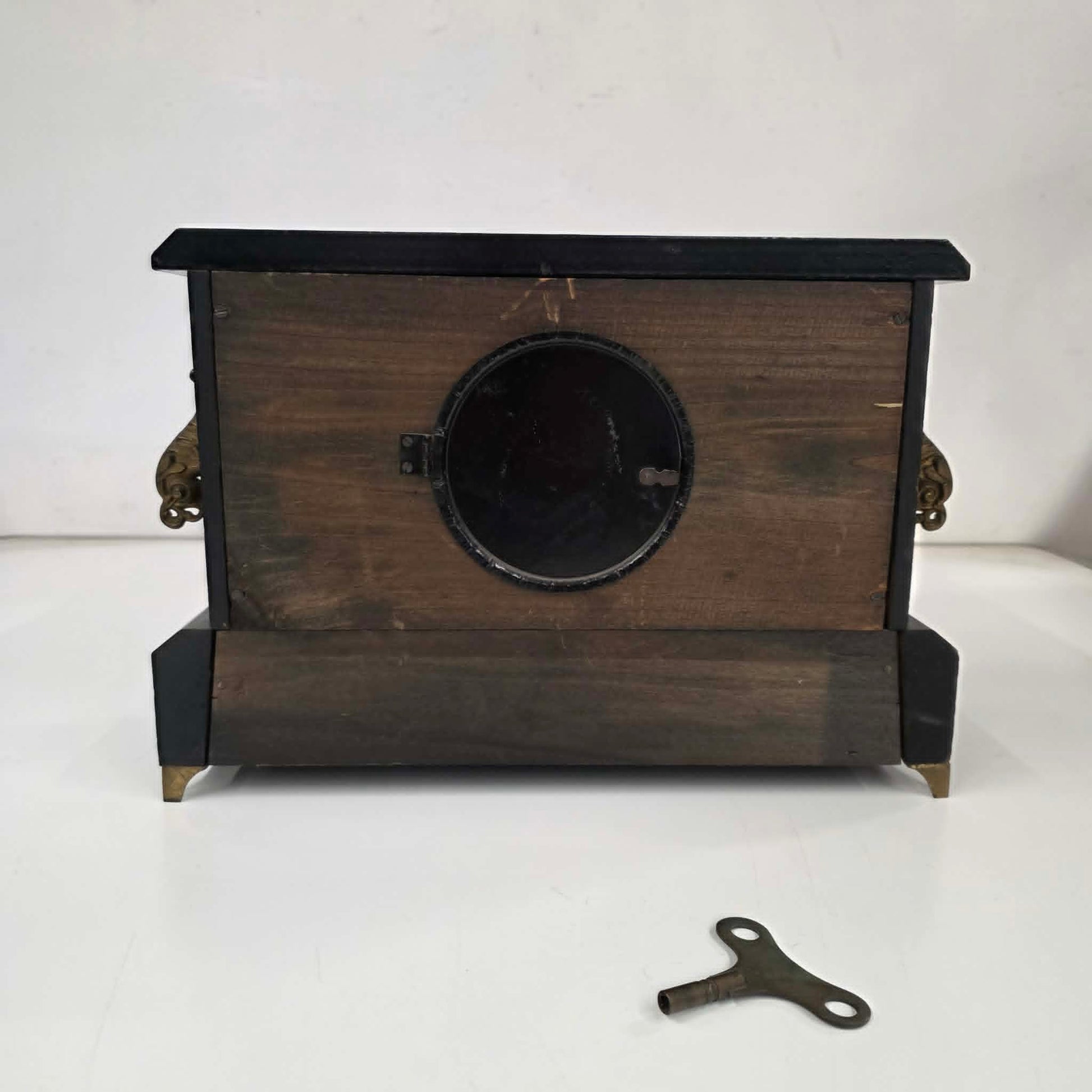 Antique E. Ingraham mantel clock with marbleized columns and bell strike movement.
