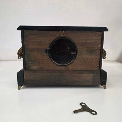 Antique E. Ingraham mantel clock with marbleized columns and bell strike movement.
