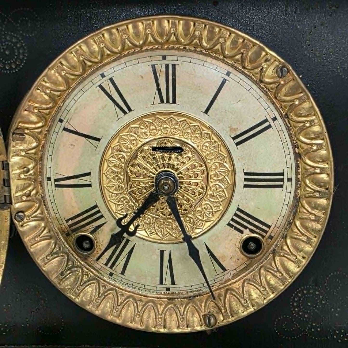Antique E. Ingraham mantel clock with marbleized columns and bell strike movement.

