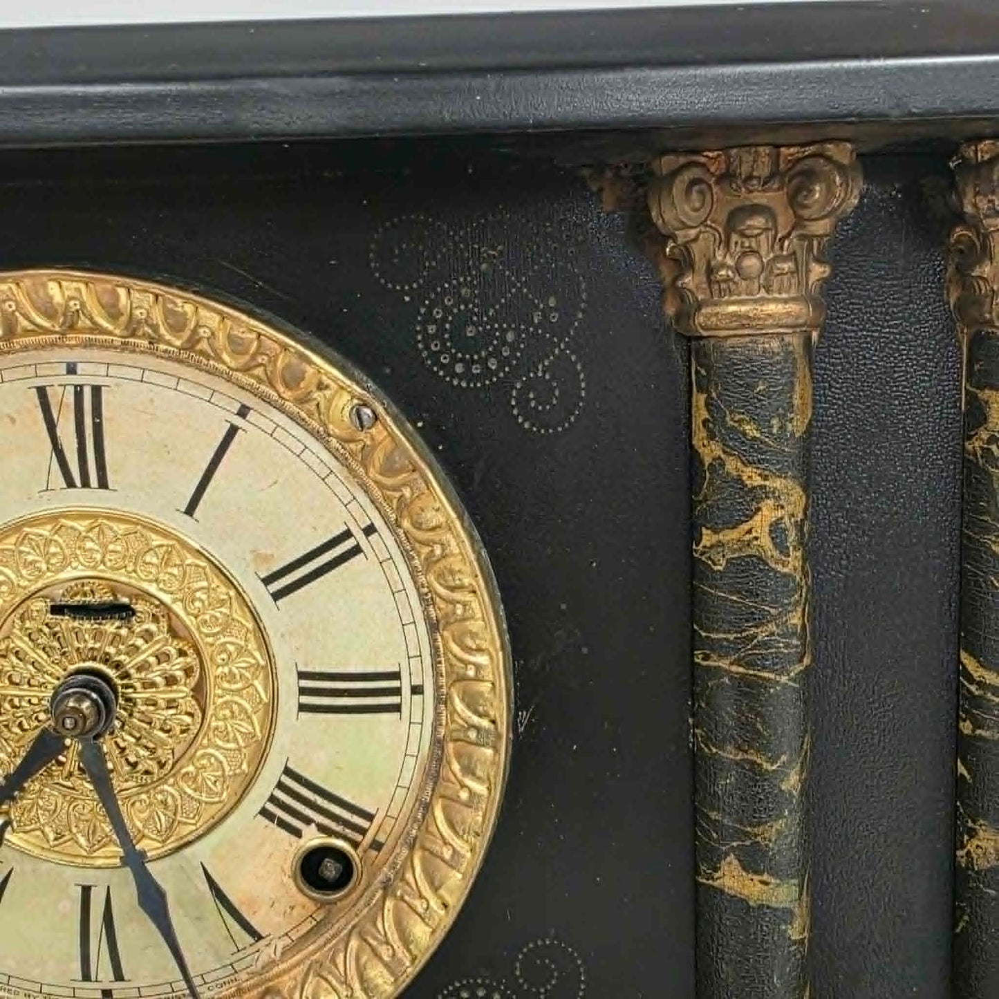 Antique E. Ingraham mantel clock with marbleized columns and bell strike movement.

