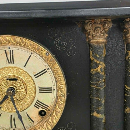 Antique E. Ingraham mantel clock with marbleized columns and bell strike movement.
