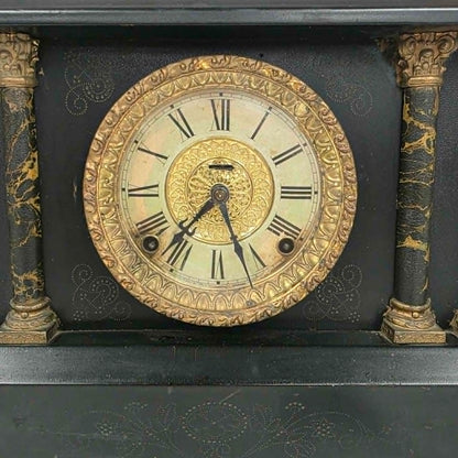 Antique E. Ingraham mantel clock with marbleized columns and bell strike movement.
