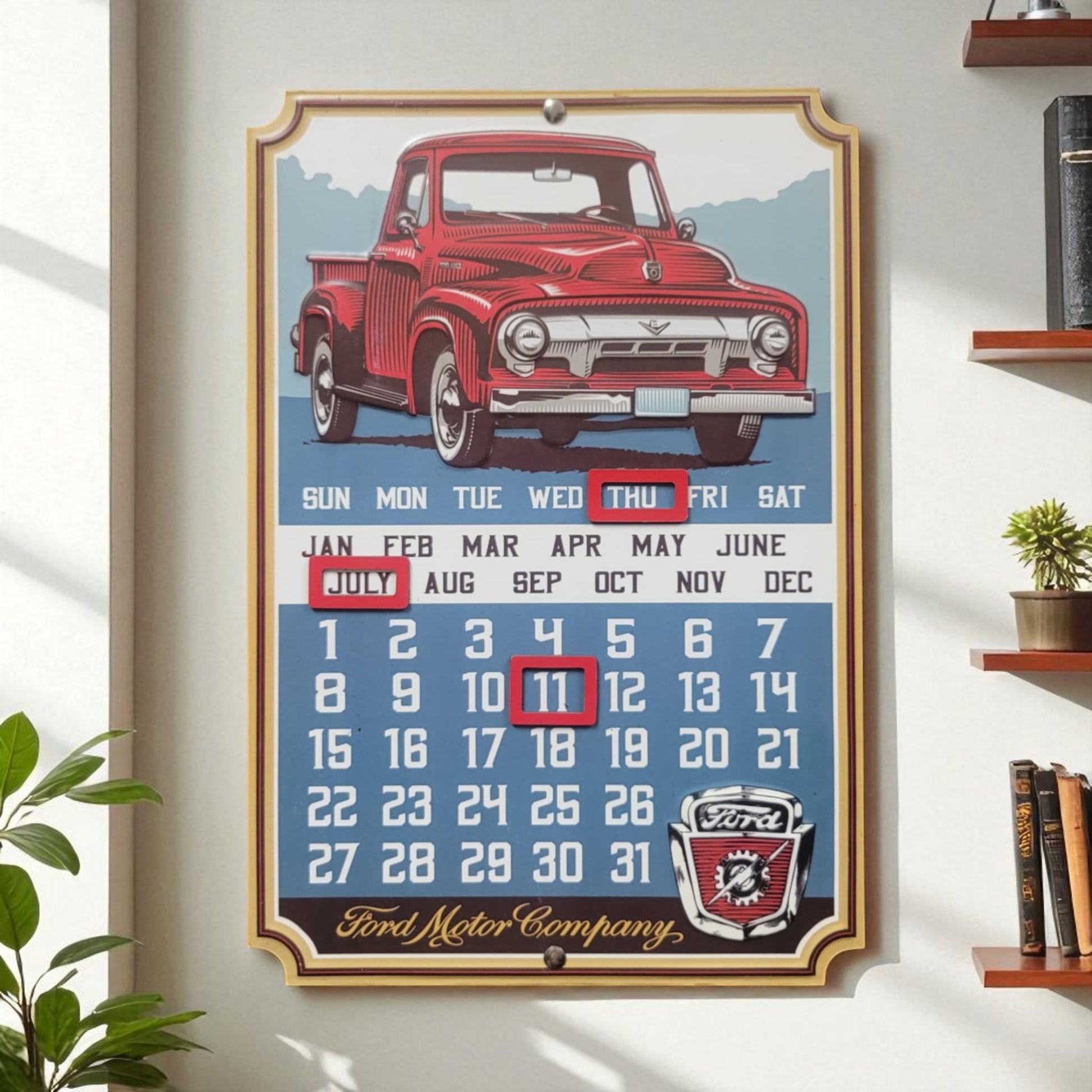 Framed calendar with a red vintage truck design on a white wall.