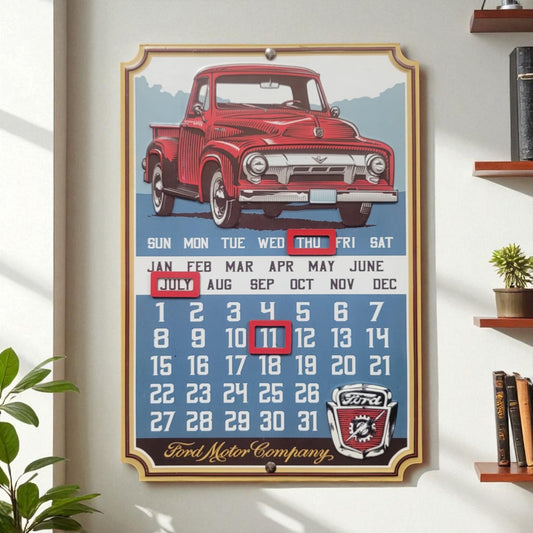 Framed calendar with a red vintage truck design on a white wall.