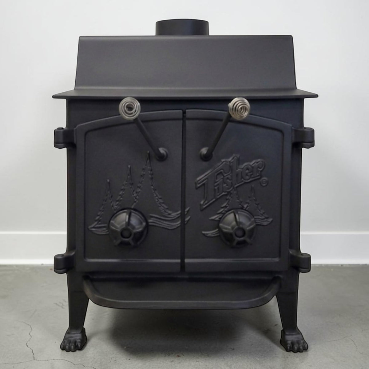 Fisher Grandma Bear wood stove with cathedral doors for dependable wood heating and off-grid living.
