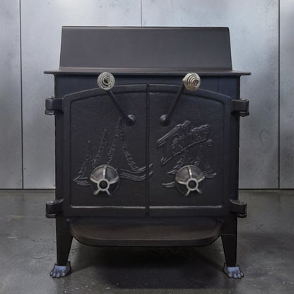 Fisher Grandma Bear wood stove with cathedral style doors and rear vent chimney cooking surface.
