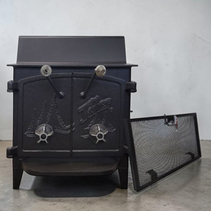 Fisher Grandma Bear wood stove with cathedral style doors and rear vent chimney cooking surface.
