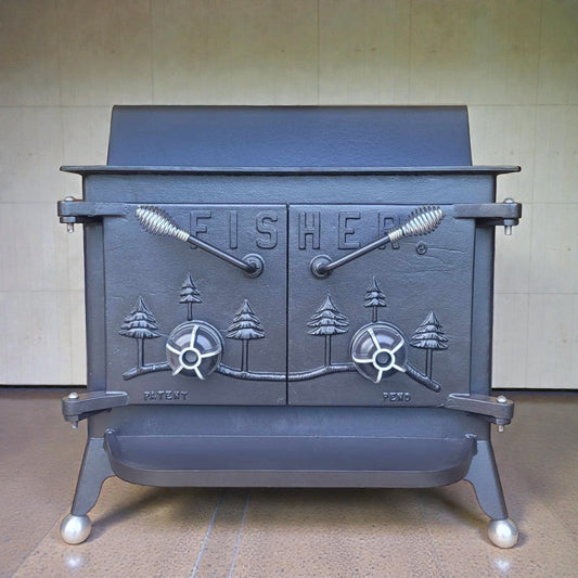 Vintage
cast iron stove with 'Fisher' branding on a neutral background