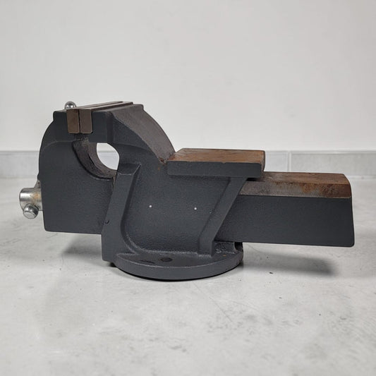 Vintage heavy duty cast iron bench vise with 5-inch jaws and rear anvil.
