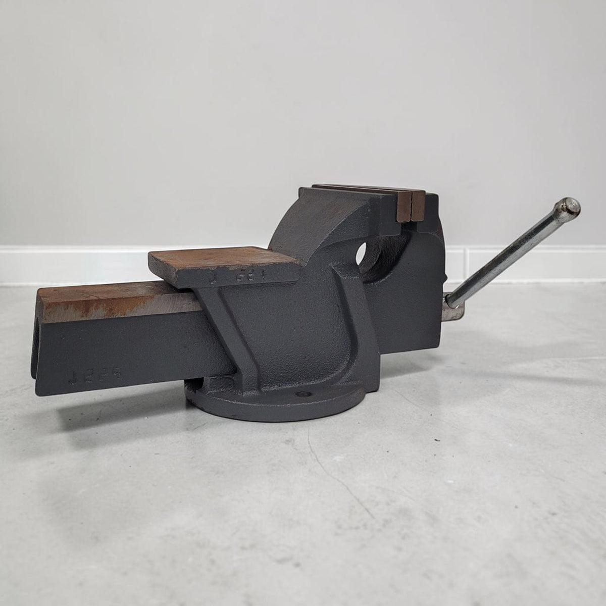 Vintage heavy duty cast iron bench vise with 5-inch jaws and rear anvil.
