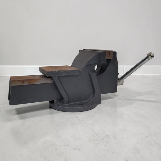 Vintage heavy duty cast iron bench vise with 5-inch jaws and rear anvil.

