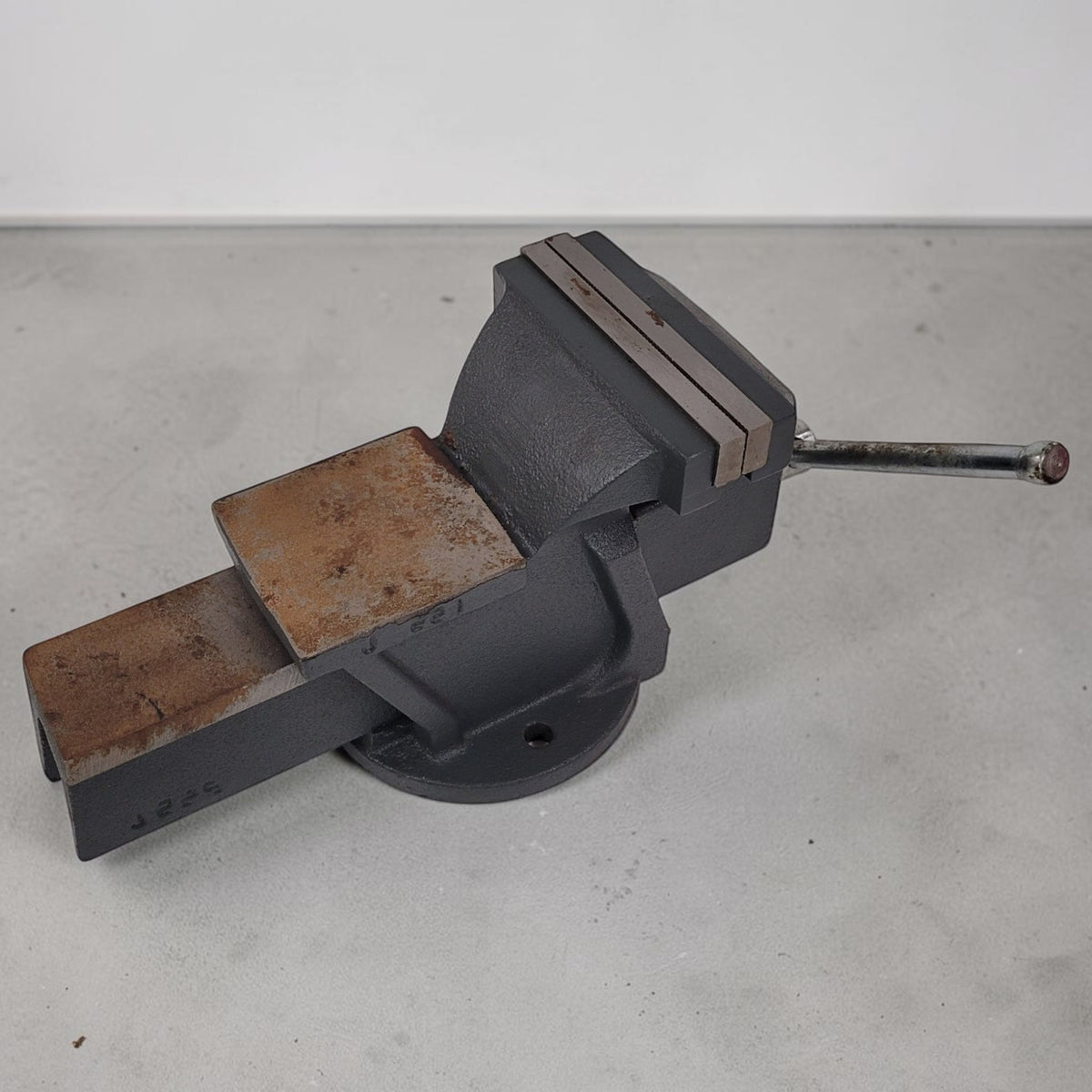 Vintage heavy duty cast iron bench vise with 5-inch jaws and rear anvil.
