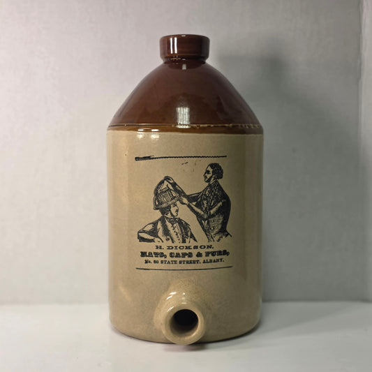 Antique H. Dickson Albany merchant crock with hat shop advertising graphic.
