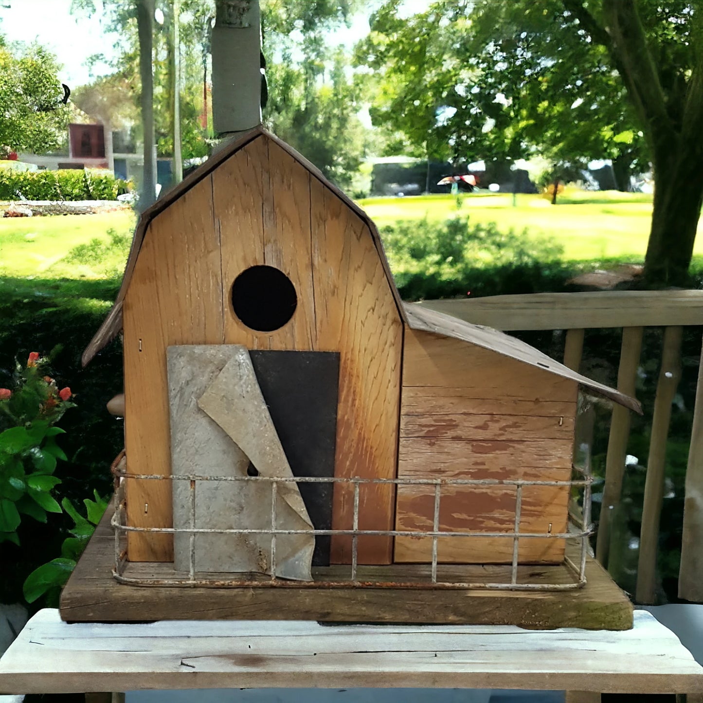 Handmade reclaimed wood barn-style birdhouse with lean-to addition and rustic folk art finish.