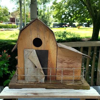 Handmade reclaimed wood barn-style birdhouse with lean-to addition and rustic folk art finish.