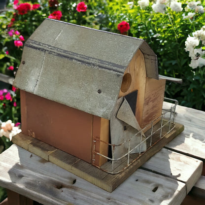 Handmade reclaimed wood barn-style birdhouse with lean-to addition and rustic folk art finish.