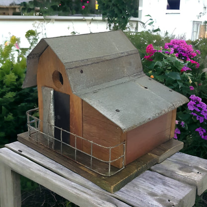 Handmade reclaimed wood barn-style birdhouse with lean-to addition and rustic folk art finish. 