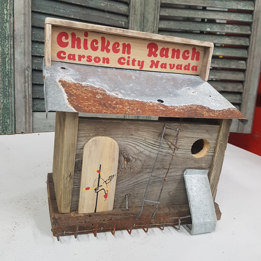 Handmade rustic Chicken Ranch folk art birdhouse made from reclaimed materials with chicken-themed artwork.
