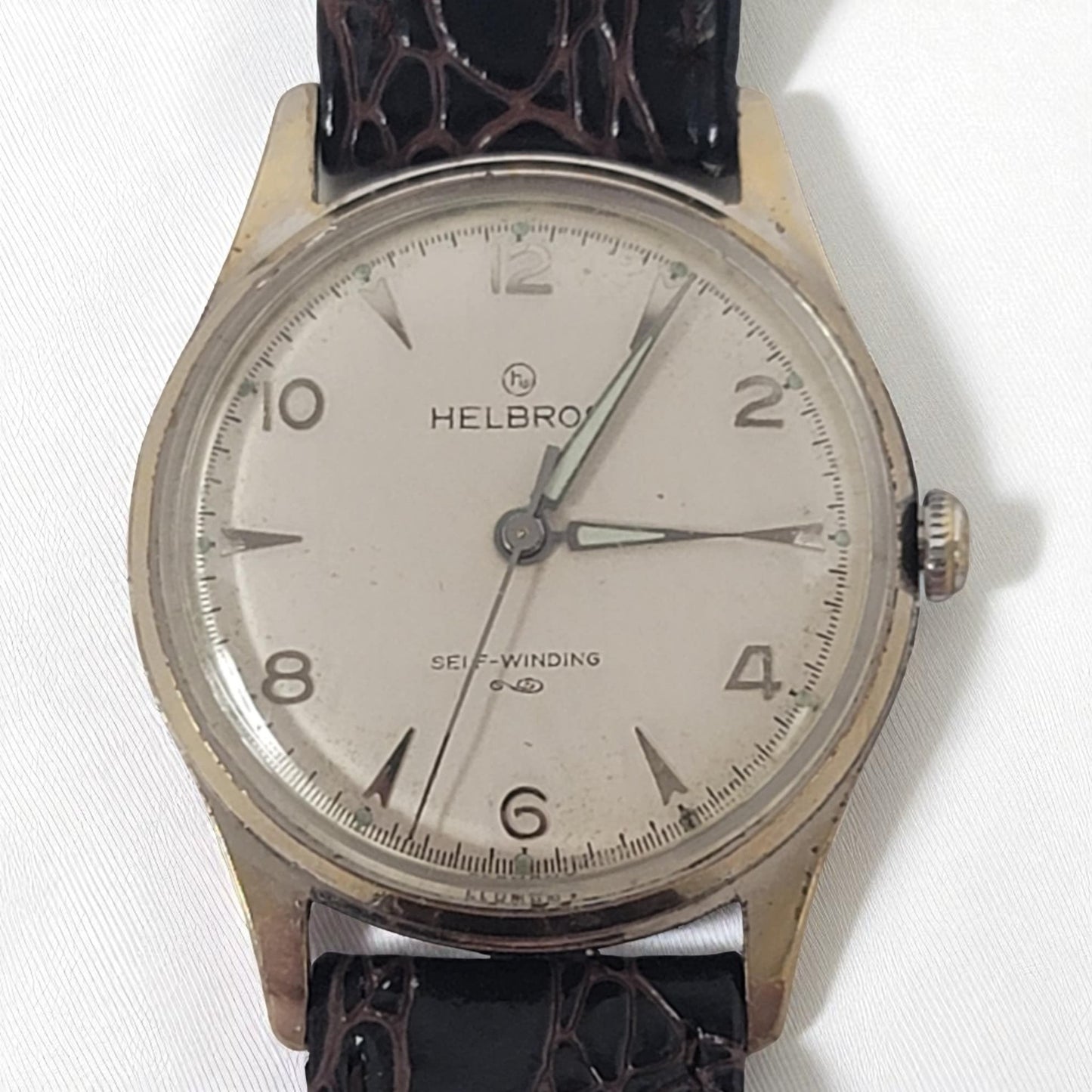 Helbros watch with a black leather strap on a white background