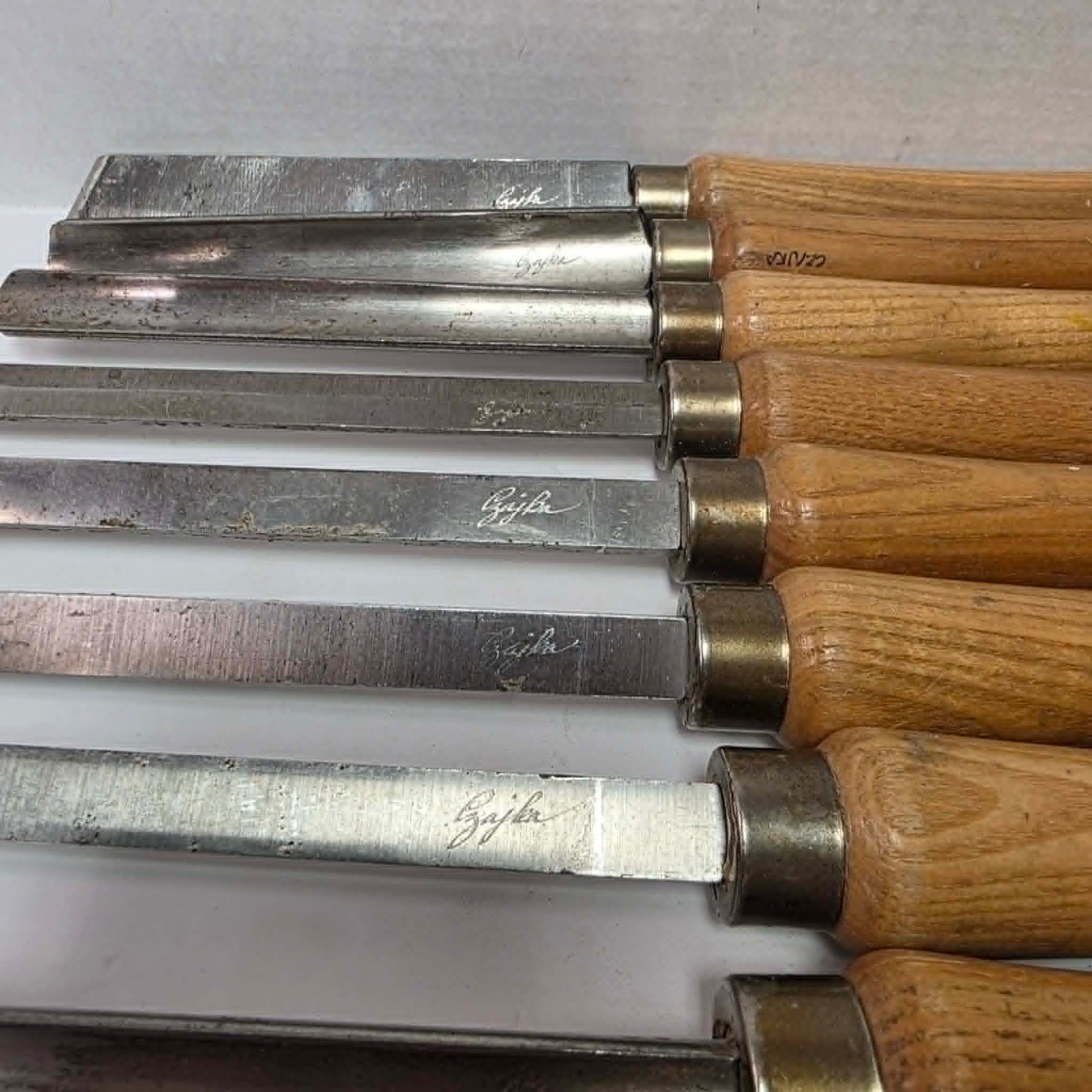 A rare signed set of eight Józef Gajka European woodturning chisels showcasing traditional Polish toolmaking craftsmanship.
