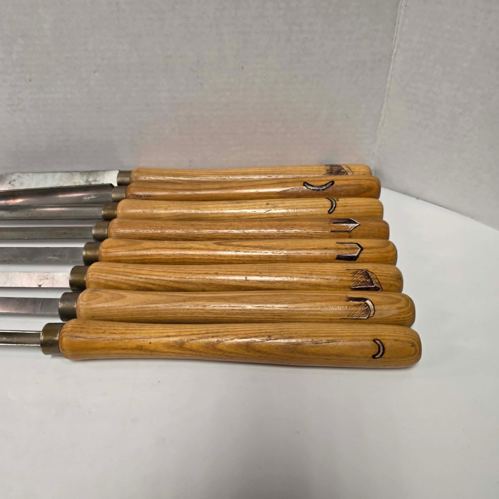 A rare signed set of eight Józef Gajka European woodturning chisels showcasing traditional Polish toolmaking craftsmanship.