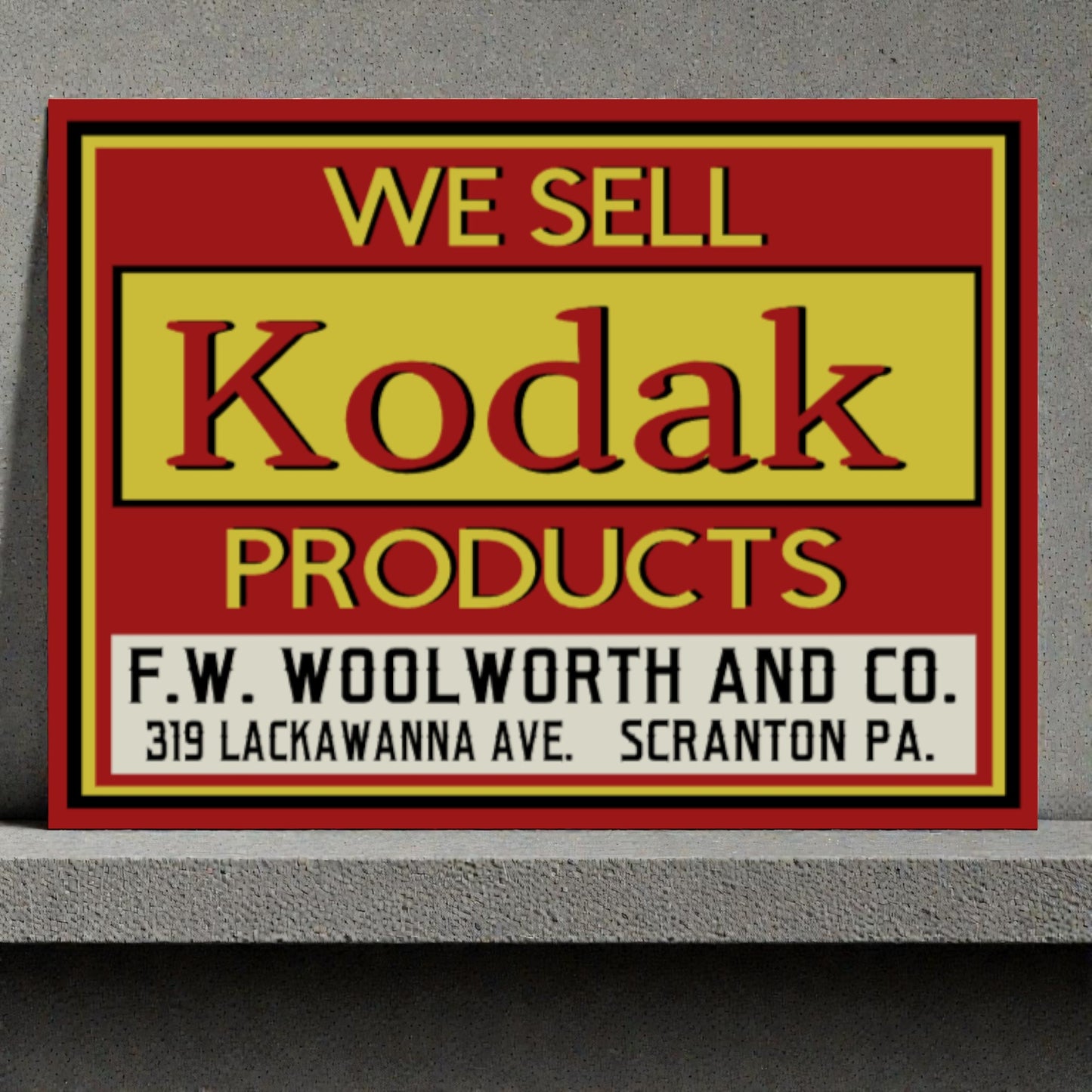 Vintage sign advertising Kodak products sold at F.W. Woolworth and Co.