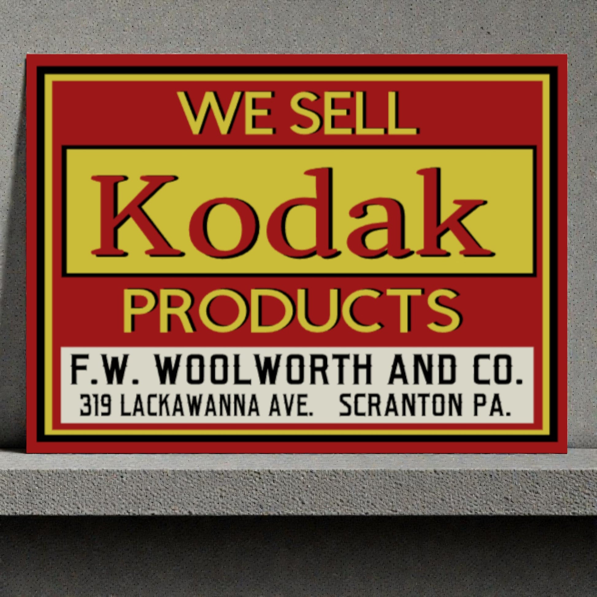 Vintage sign advertising Kodak products sold at F.W. Woolworth and Co.