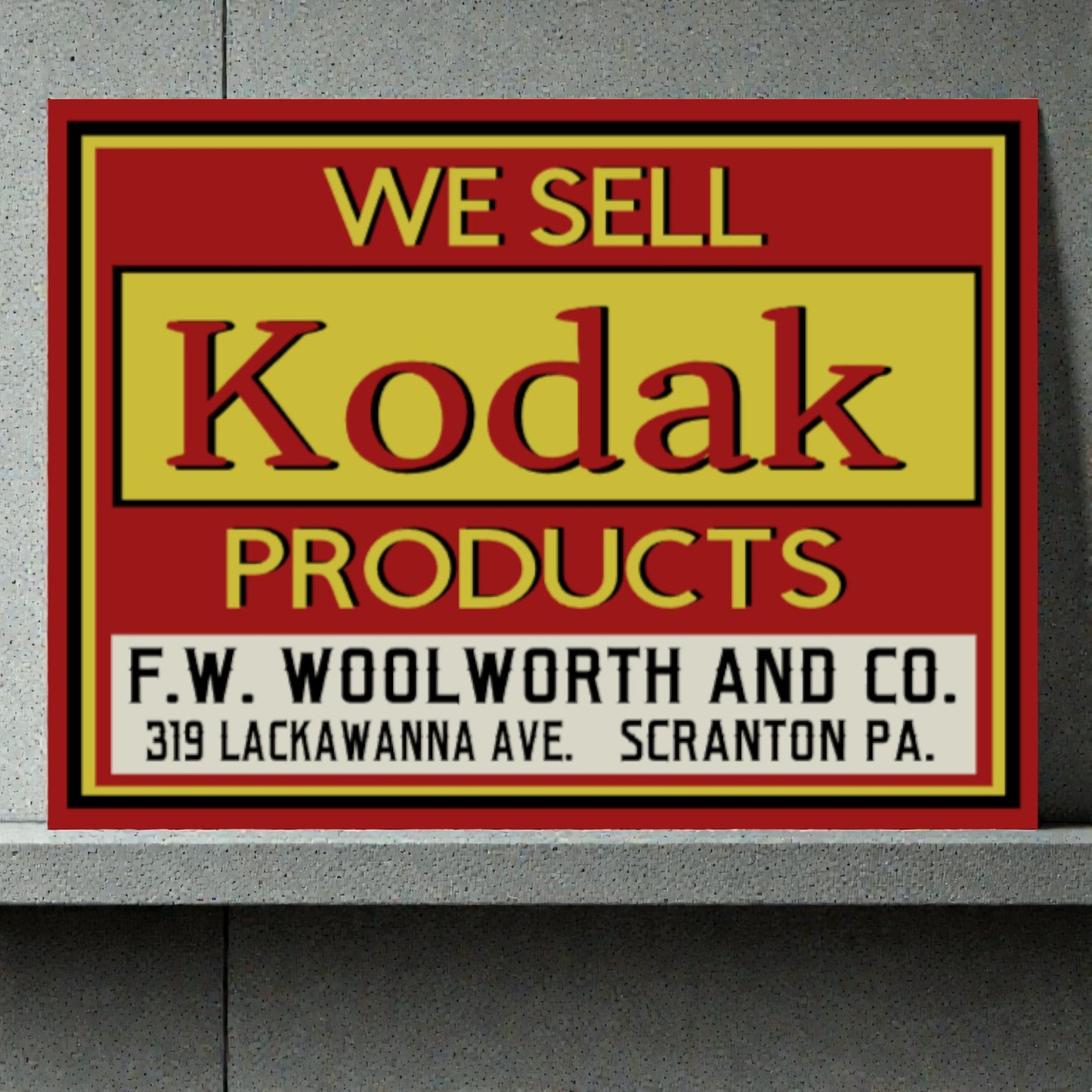 Vintage-style sign advertising Kodak products at F.W. Woolworth and Co.