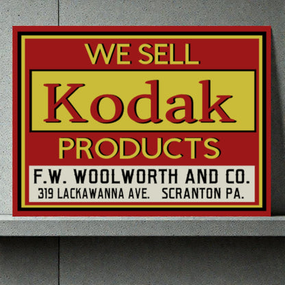 Vintage-style sign advertising Kodak products at F.W. Woolworth and Co.