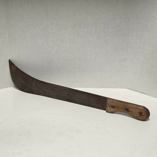 Large antique wooden handled machete with curved ridged blade.
