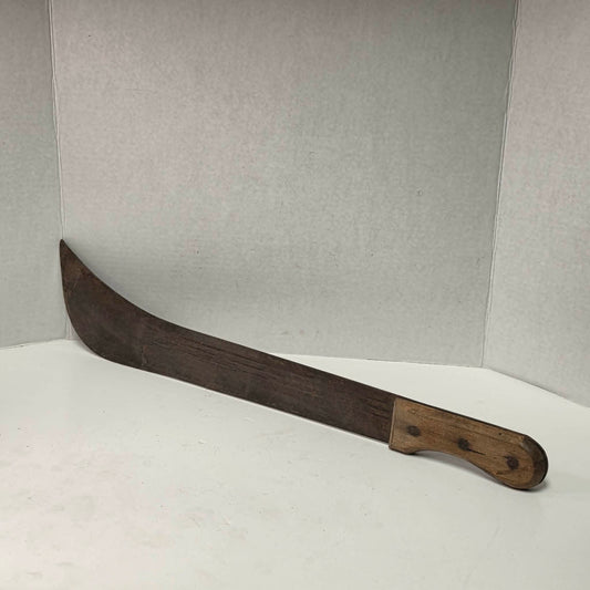 Large antique wooden handled machete with curved ridged blade.
