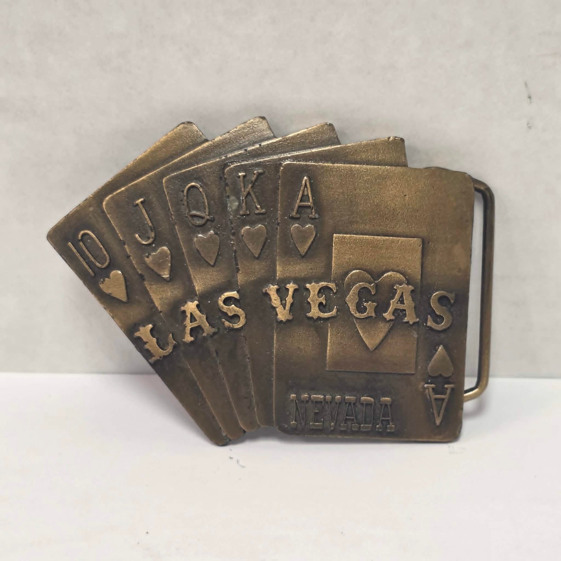 Vintage brass Las Vegas Nevada belt buckle featuring a straight flush poker hand by Pacific Brass and Buckle Co.
