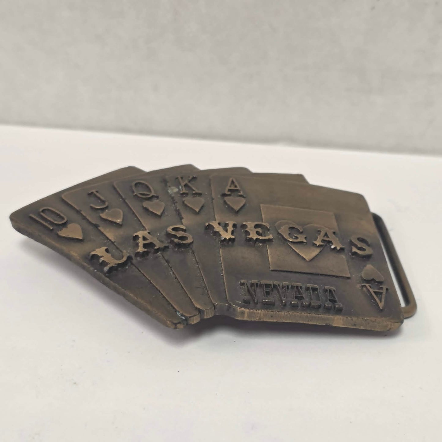 Vintage brass Las Vegas Nevada belt buckle featuring a straight flush poker hand by Pacific Brass and Buckle Co.
