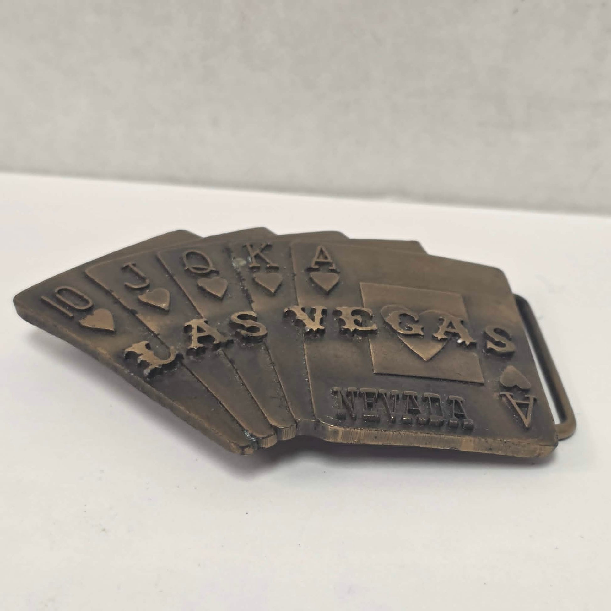 Vintage brass Las Vegas Nevada belt buckle featuring a straight flush poker hand by Pacific Brass and Buckle Co.
