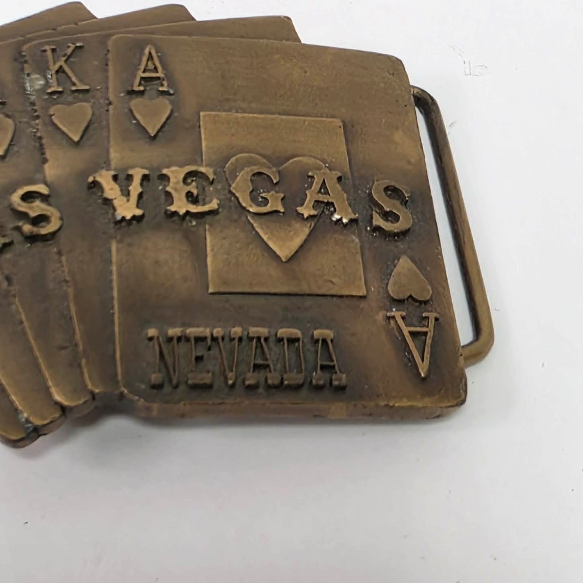 Vintage brass Las Vegas Nevada belt buckle featuring a straight flush poker hand by Pacific Brass and Buckle Co.
