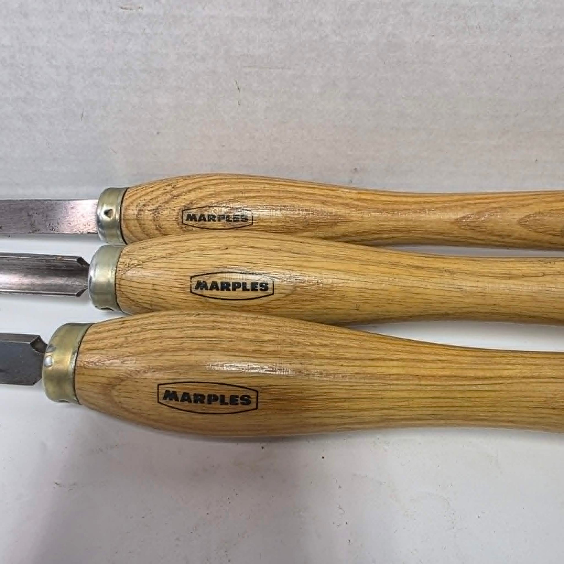 Three vintage Marples woodturning chisels including gouge, parting tool, and turning chisel.