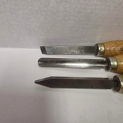 Three vintage Marples woodturning chisels including gouge, parting tool, and turning chisel.