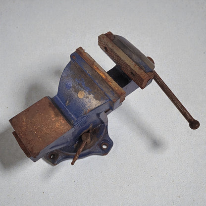Rust-colored vise on a light gray background