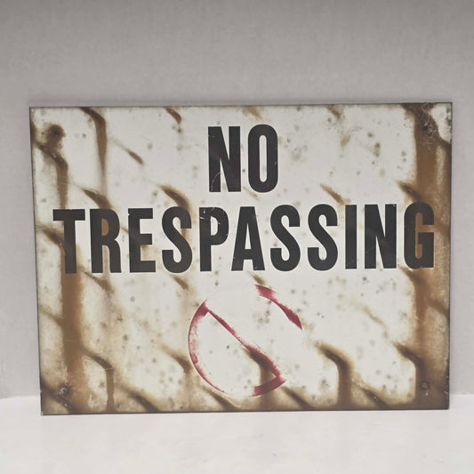 Original vintage weathered No Trespassing metal sign with natural aged patina.
