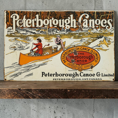 Rustic Peterborough Canoes Co. Limited aluminum sign featuring Peterborough Ontario Canada canoe company décor.
