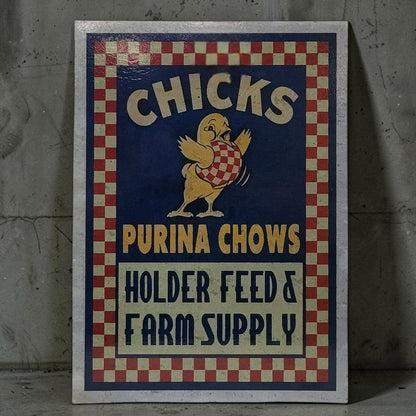 Vintage-style sign for Purina Chows with a chicken illustration on a textured wall.