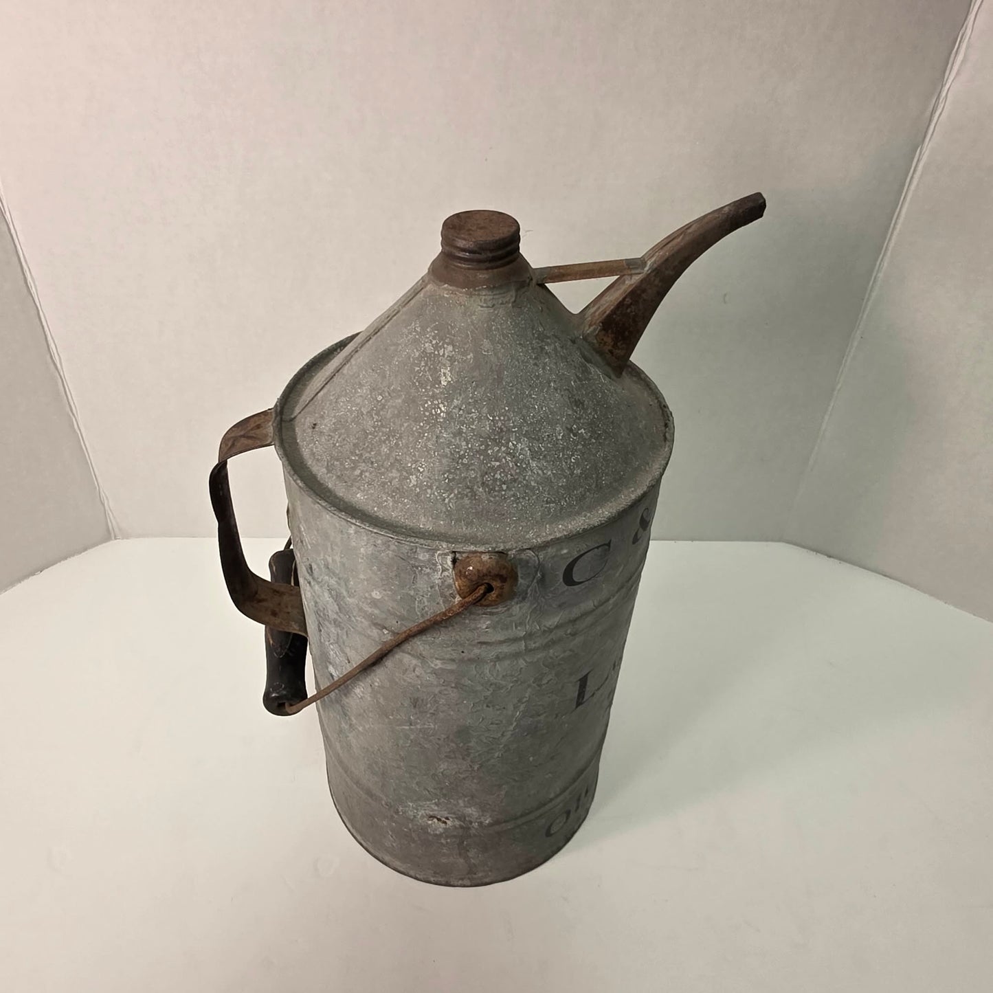 Antique galvanized oil can with classic railroad-inspired industrial character.