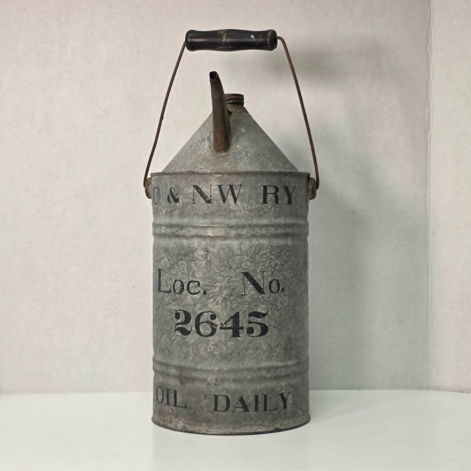 Antique galvanized oil can with classic railroad-inspired industrial character.