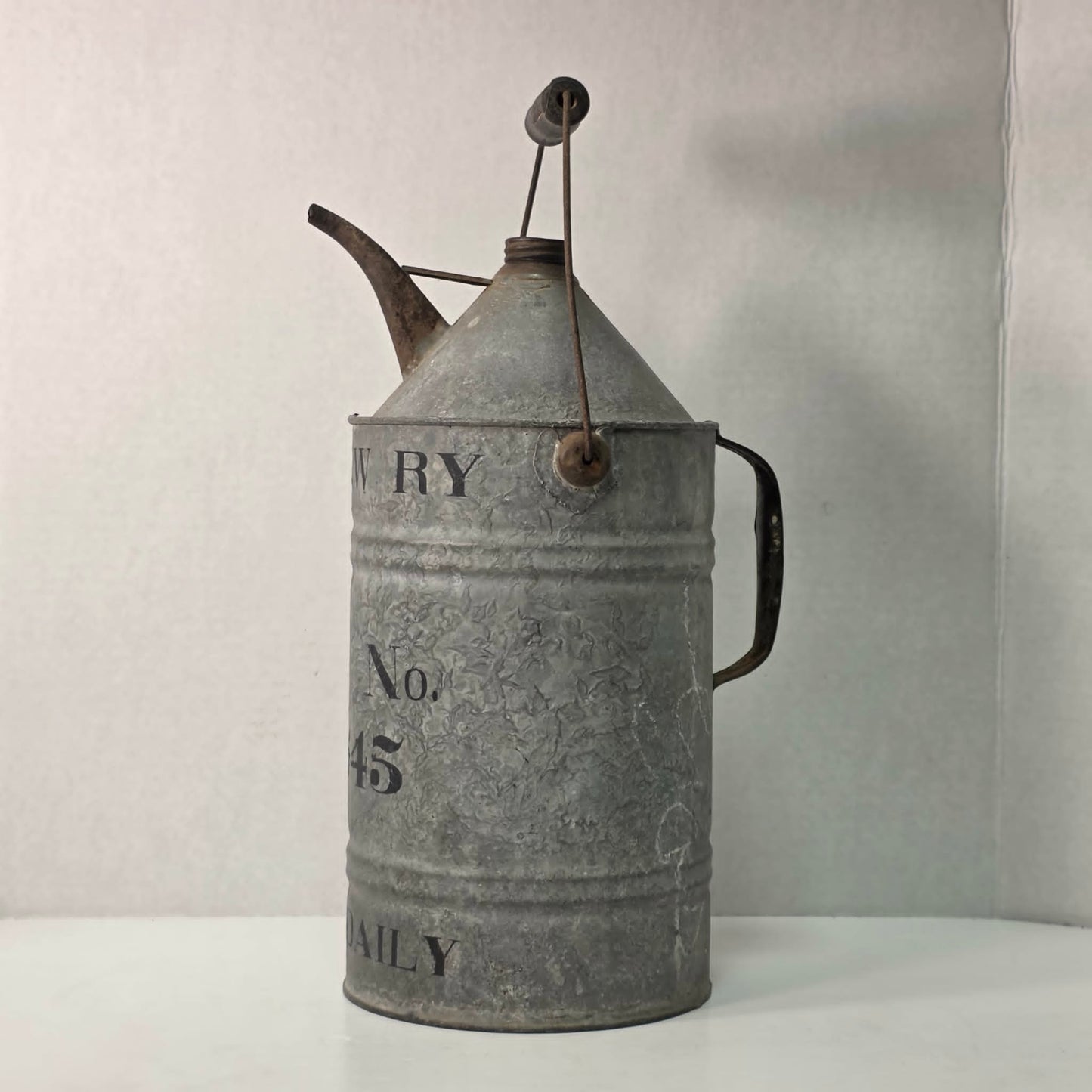 Antique galvanized oil can with classic railroad-inspired industrial character.